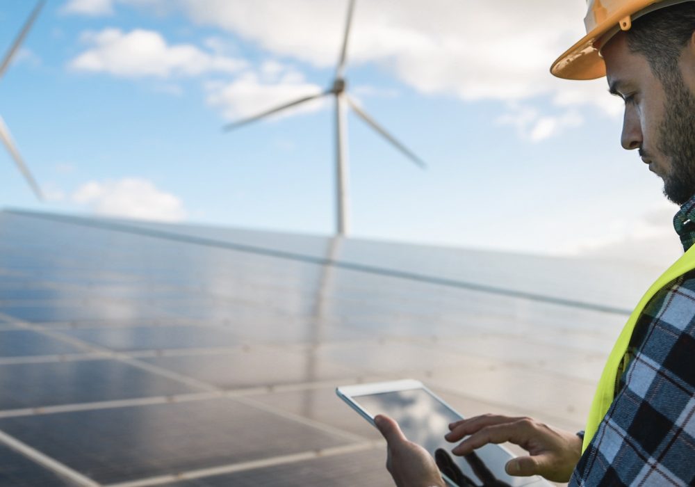 young-man-working-with-digital-tablet-at-renewable-energy-farm.jpg